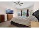 Well-lit main bedroom featuring a ceiling fan and sliding glass doors at 2801 Boat Cove Cir, Kissimmee, FL 34746
