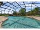 Sparkling screened-in pool surrounded by lush landscaping providing a private and relaxing outdoor retreat at 2801 Boat Cove Cir, Kissimmee, FL 34746
