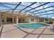 Open-air pool with large patio and screened enclosure, perfect for enjoying the outdoors with ample space for lounging at 2801 Boat Cove Cir, Kissimmee, FL 34746