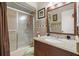Cozy bathroom featuring a shower with glass doors, granite countertop, and decorative accents at 2933 N Chickasaw Trl, Orlando, FL 32817