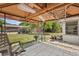 This cozy covered patio has tile flooring, which offers a serene spot for relaxation and outdoor entertainment at 2933 N Chickasaw Trl, Orlando, FL 32817