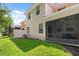 Backyard featuring grass, the rear of the house, and a screened in lanai at 299 Terracina Dr, Sanford, FL 32771