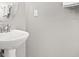 Bathroom sink with chrome faucet, towel bar, rounded mirror, and neutral paint at 299 Terracina Dr, Sanford, FL 32771