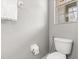 Half bathroom shows toilet, window for natural light, towel rack, and neutral paint at 299 Terracina Dr, Sanford, FL 32771
