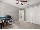Bedroom with large closet, carpet, ceiling fan, light gray walls and white trim at 299 Terracina Dr, Sanford, FL 32771