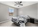 Bright bedroom boasts a ceiling fan, window with neighborhood views, and neutral gray paint at 299 Terracina Dr, Sanford, FL 32771