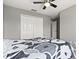 Bright bedroom shows a ceiling fan, closet with bifold doors, and neutral gray paint at 299 Terracina Dr, Sanford, FL 32771