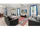 Bright living room boasts tile floors, ceiling fan and sliding glass door to screened patio at 299 Terracina Dr, Sanford, FL 32771