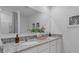 Elegant bathroom featuring double sinks, granite countertops, and modern fixtures, creating a spa-like experience at 3665 Marlberry Way, Sanford, FL 32773