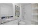Clean, well-lit bathroom with white cabinetry, granite countertop, shower-tub combo, and decorative wall art at 3665 Marlberry Way, Sanford, FL 32773