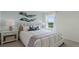 Inviting bedroom with neutral decor, a comfortable queen-sized bed, and a window providing natural light at 3665 Marlberry Way, Sanford, FL 32773