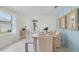 Open-concept dining room featuring decoratively paneled walls, dining table and bench seating, and access to entryway at 3665 Marlberry Way, Sanford, FL 32773
