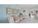 Dining room with a blue accent wall, decorative mirrors, table set for four, and open access to the kitchen at 3665 Marlberry Way, Sanford, FL 32773