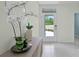 Bright foyer featuring neutral walls, modern decor and a view to the outdoors through a glass front door at 3665 Marlberry Way, Sanford, FL 32773