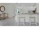 Bright kitchen with granite countertops and modern white cabinets, offering a cozy breakfast bar with seating at 3665 Marlberry Way, Sanford, FL 32773