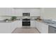Modern kitchen featuring white cabinets, stainless steel appliances, and granite countertops at 3665 Marlberry Way, Sanford, FL 32773