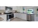 Modern kitchen with stainless steel appliances, white cabinets and granite countertops at 3665 Marlberry Way, Sanford, FL 32773
