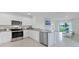Contemporary kitchen featuring white cabinets, stainless steel appliances, and an island with granite countertops at 3665 Marlberry Way, Sanford, FL 32773
