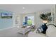 Comfortable living room featuring a blue accent wall, plush sofa, and a serene view through the sliding glass doors at 3665 Marlberry Way, Sanford, FL 32773