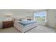 Serene bedroom with a large window, cozy bedding, and stylish nightstands offering tranquil views at 3665 Marlberry Way, Sanford, FL 32773