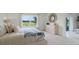 Bright bedroom with a large window offering views of the landscape, comfortable bedding, and stylish furniture at 3665 Marlberry Way, Sanford, FL 32773
