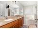 This bathroom has a double vanity, large mirror, and soaking tub at 400 Bridge Creek Blvd, Ocoee, FL 34761