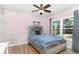 Comfortable bedroom with a ceiling fan, wood floors and stylish headboard at 400 Bridge Creek Blvd, Ocoee, FL 34761