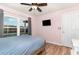 This bedroom features a ceiling fan, wood floors and access to the pool at 400 Bridge Creek Blvd, Ocoee, FL 34761