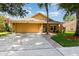 Inviting home exterior with a two-car garage, brick-lined walkway, and well-kept landscaping at 400 Bridge Creek Blvd, Ocoee, FL 34761