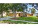 Charming single-story home with a well-manicured lawn, lush trees, and a welcoming front entrance at 400 Bridge Creek Blvd, Ocoee, FL 34761