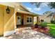 Covered front porch with brick paving and decorative plants enhancing the entrance of the home at 400 Bridge Creek Blvd, Ocoee, FL 34761