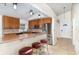 Eat-in kitchen featuring stainless steel appliances, tile backsplash, and counter seating for three at 400 Bridge Creek Blvd, Ocoee, FL 34761
