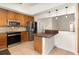 A modern kitchen features stainless steel appliances and granite countertops at 400 Bridge Creek Blvd, Ocoee, FL 34761