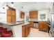 Functional kitchen with stainless steel appliances, wood cabinets, breakfast bar and tile flooring at 400 Bridge Creek Blvd, Ocoee, FL 34761