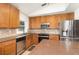 Well-maintained kitchen with stainless steel appliances, ample counter space, and classic wood cabinetry at 400 Bridge Creek Blvd, Ocoee, FL 34761