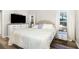 This main bedroom features wood floors, a TV, and bright light at 400 Bridge Creek Blvd, Ocoee, FL 34761