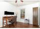 The office has a wood desk, two monitors, and a wooden armoire at 400 Bridge Creek Blvd, Ocoee, FL 34761