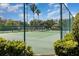 Community tennis court surrounded by fencing and lush landscaping at 400 Bridge Creek Blvd, Ocoee, FL 34761