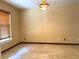 Cozy bedroom with tile floors, wood trim, and a window providing natural light at 4105 Quando Dr, Belle Isle, FL 32812