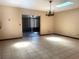 Bright dining room with tile floors, skylight, chandelier, and sliding glass doors to the porch at 4105 Quando Dr, Belle Isle, FL 32812