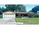 Charming single-story home featuring a two-car garage and a well-maintained lawn with mature landscaping at 4105 Quando Dr, Belle Isle, FL 32812