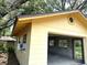 External view of the home's garage featuring painted yellow siding and brown trim at 4105 Quando Dr, Belle Isle, FL 32812