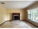 Inviting living room with a fireplace, tile floors, and large windows offering plenty of natural light at 4105 Quando Dr, Belle Isle, FL 32812