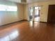 Spacious living room with hardwood floors, a sliding door to the porch, and a classic chandelier at 4105 Quando Dr, Belle Isle, FL 32812