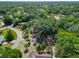 A stunning aerial view of the home nestled among lush greenery in a serene neighborhood setting at 43 Lake Court Loop, Ocala, FL 34472