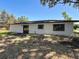 Backyard featuring a home with a sliding door leading to the outside at 43 Lake Court Loop, Ocala, FL 34472