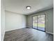 Bright bedroom with gray walls and a sliding glass door to the outside at 43 Lake Court Loop, Ocala, FL 34472
