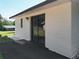 Exterior of home featuring a sliding door leading to the backyard at 43 Lake Court Loop, Ocala, FL 34472