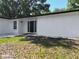 Charming home exterior featuring a clean white facade, neatly kept lawn, and inviting front entrance at 43 Lake Court Loop, Ocala, FL 34472