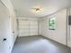 Bright garage with gray floor, white walls, and built in storage at 43 Lake Court Loop, Ocala, FL 34472